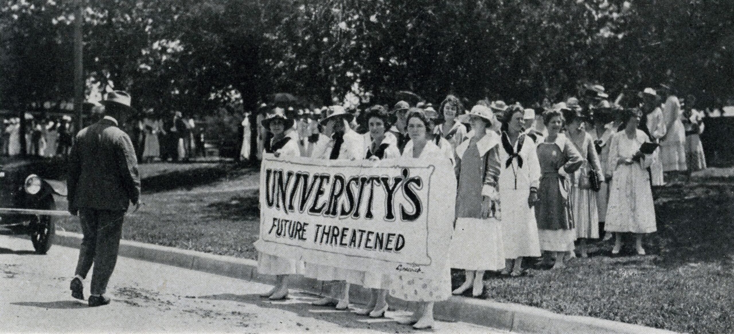 Women at march hold sign that says 