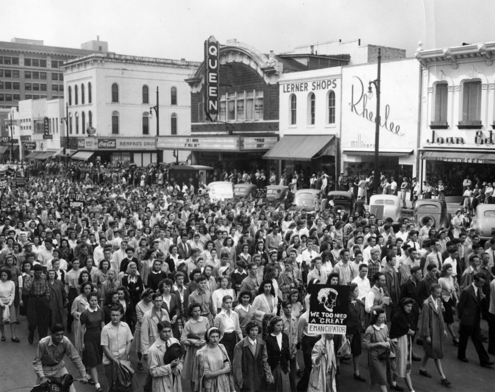 Crowd walking in street protesting President Homer Rainey’s firing